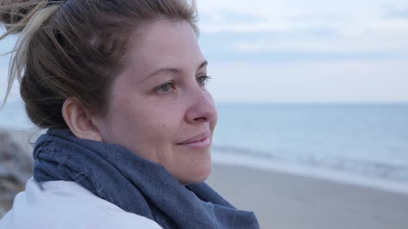 Woman near sea coast enjoyment 4K 2160p 30fps UltraHD footage - Before sunset blond Caucasian female
