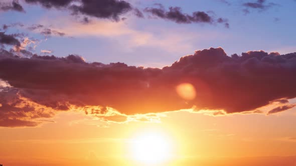 Evening sky with setting sun through clouds at sunset, cloudy landscape