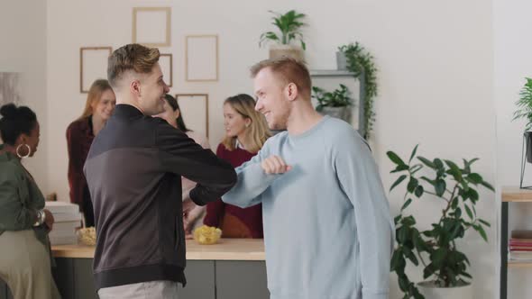 Men Greeting Each Other at House Party alt