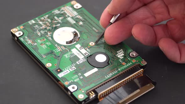 Computer hard drive being inspected by a technician. alt