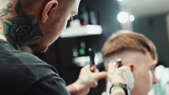 Hairdresser Makes Haircut To the Client alt