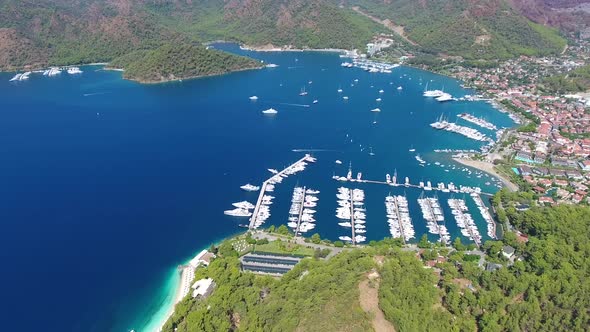 Small City Houses, Beautiful Marina and Touristic Boats in a Cove Surrounded by Forest by Sea alt