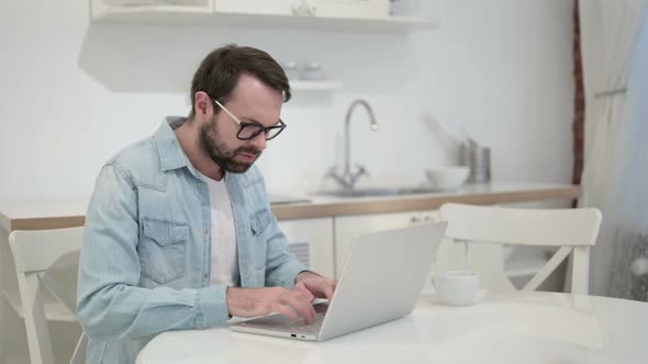 Anxious Beard Young Man Getting Angry on Laptop in Office alt