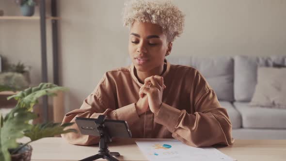 African Woman Blogger Recording Video for Followers on Smartphone Camera alt