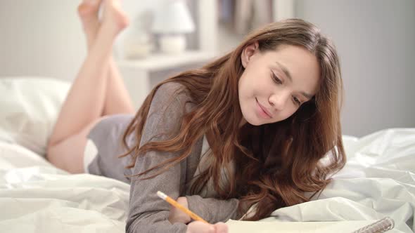 Tenderness Woman Thinking with Pencil at Bed alt