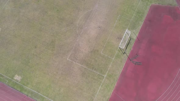 Drone Flying Across Track and Field