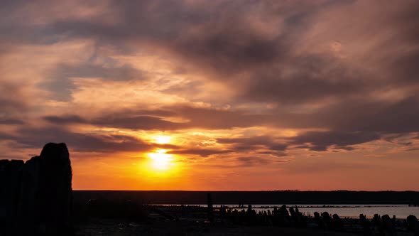 Romantic Colorful Sunset Timelapse on the Estuary Water. Setting Sun Goes Over the Mountain alt