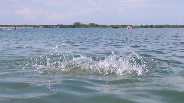A Child Swimming Drowning Splashing Hands Diving Under Water on the Beach alt