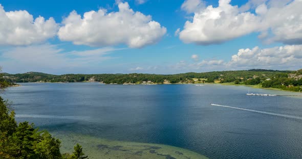 Perfect Summer Day with Puffy Clouds over Blue Lake