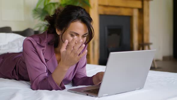 Middle Aged Woman in Front of a Laptop Monitor in Bed alt