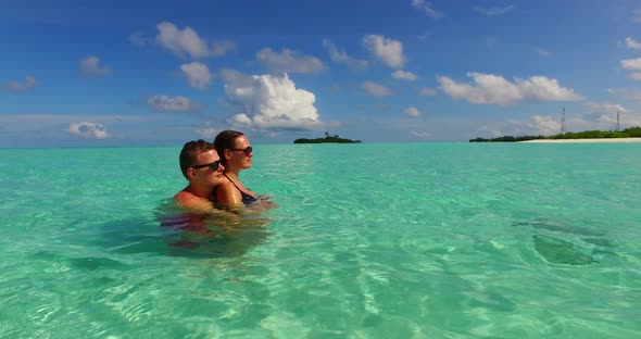 Happy boy and girl married on vacation enjoy life on beach on sunny white sandy  alt