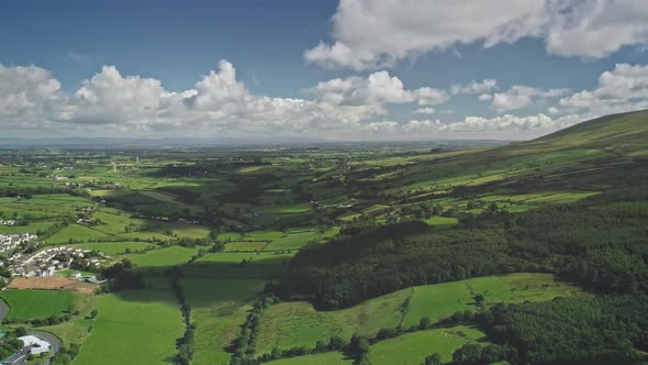 Hyperlapse Ireland Rural Scape Aerial View Farmlands Fields and Cityscape with White Houses Roads