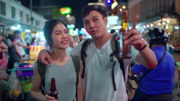 Couple drinking alcohol or beer while hangout at The Khao San Road. alt
