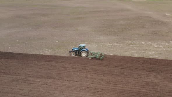 Tractor Plows the Field. Preparation of Soil For Sowing alt
