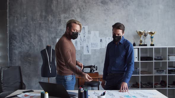 Workplace of young and talented fashion designer. Tailor and his business partner. alt