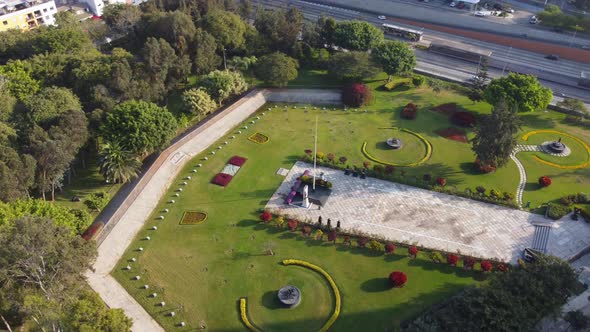 Drone video of "Parque Reducto" a park in Miraflores district of Lima, Peru. Green grass and trees c alt