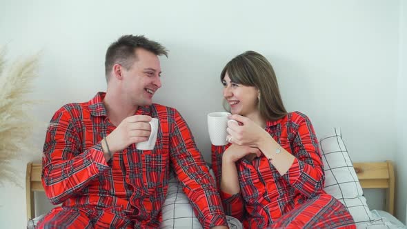Happy Couple Drinking Tea in Bed in the Morning alt