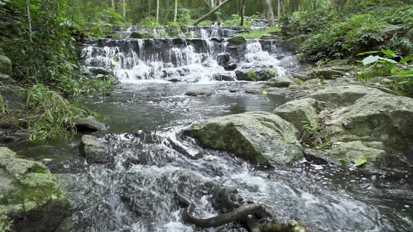 Beautiful stream and waterfall in tropical forest at Namtok Samlan National Park - Slow Motion