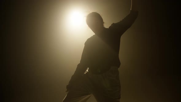 Closeup of Professional Dancer Teenager Dancing Contemporary on Dark Background alt