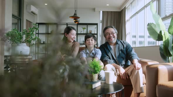 Asian family sit relax positive conversation with son, happiness smile boy casual talking