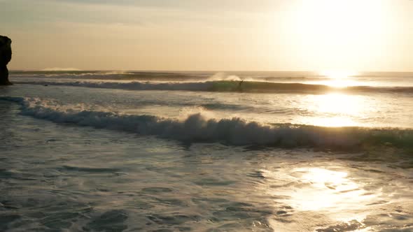 Moving over large waves at sunset