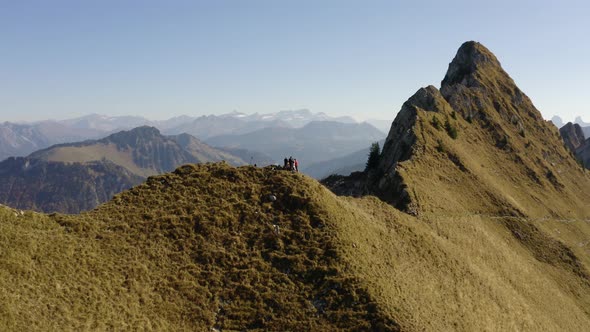 Low aerial orbiting hikers on summit "La Cape au Moine", Vaud - Switzerland alt