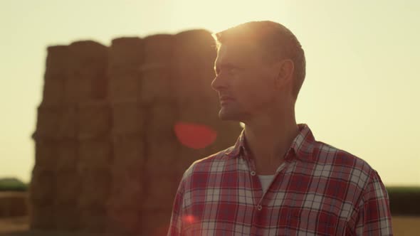 Farm Worker Golden Sunlight at Hay Bales Closeup alt