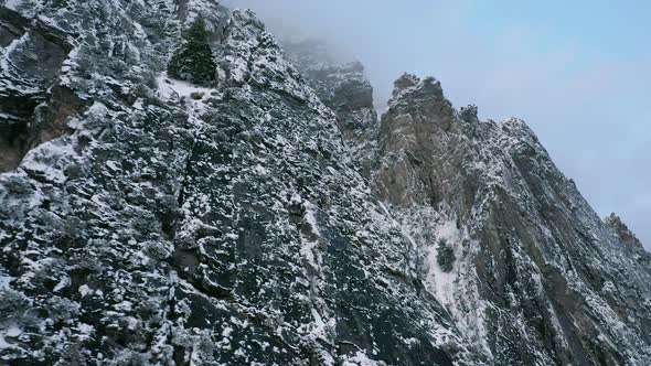Aerial view of jagged mountains covered in snow alt