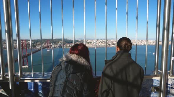 Young Family Couple at Observation Deck of Christ the King Statue in Lisbon