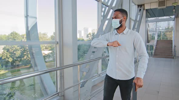 Successful African American Business Man with Folder Wears Medical Face Mask Walking Down Corridor alt