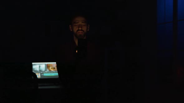 Young Man Giving a Voice Command To His Smart Light Application alt