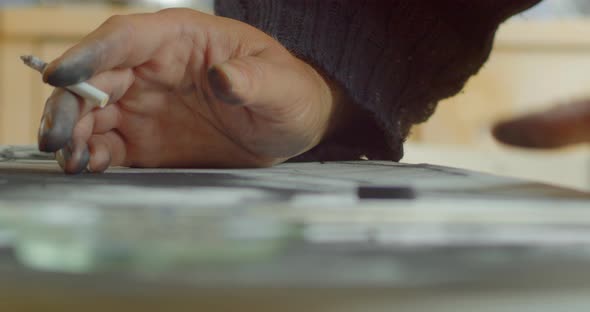 Chain smoking habit as a overworked canvas artist alt