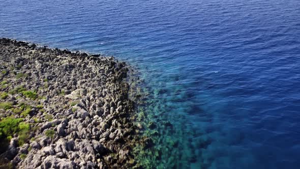 Landscape of the Sea with Reef Bottom and Transparent Water Next to Rocky Coast Filmed By Drone alt