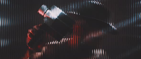 Man in shutter lights looking through clear panel with vintage camera alt