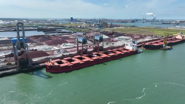 Cranes Unloading a Bulk Carrier Ship at Port alt