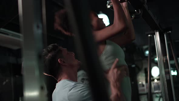 Sport and fitness concepts, Trainer and young woman, Personal instructor help young woman in gym alt