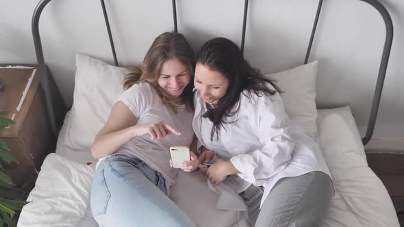 Young Women in White T-Shirt Falling on Couch Connection People Use Smartphone alt