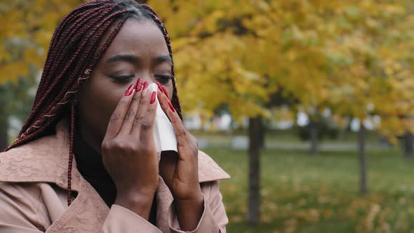 Unhealthy Young African Lady Using Paper Tissue Wiping Runny Nose alt