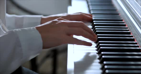 Woman or Girl Student or Professional Pianist Plays Classical Music on a Beautiful White Piano a alt