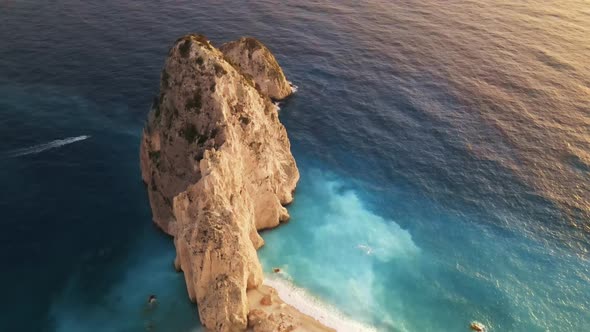 Aerial drone view of the Ionian Sea coast of Zakynthos, Greece. Rocky ridge, floating boat alt