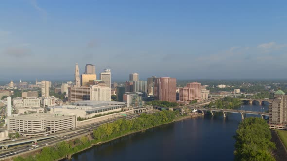 Aerial of busy street and high-rise buildings along river coast alt