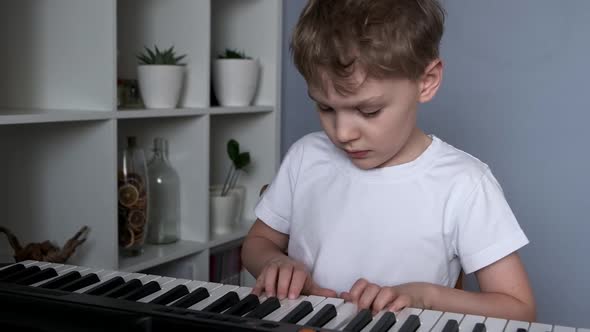 Boy Playing Synthesizer at Home