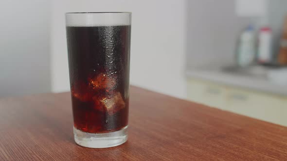 Cola drink in Transparent Glass The camera Moves Around the Table in the kitchen alt