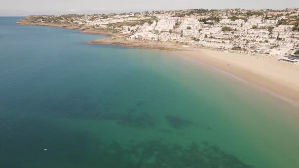 Tranquil scene, calm emerald ocean and white townhouses of Praia da Luz. Panoramic aerial alt