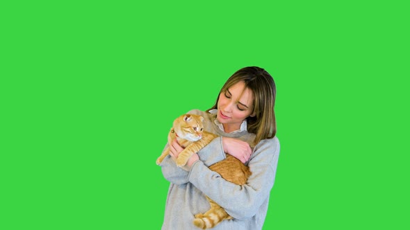 Beautiful Woman Smiling and Hugging Her Cat on a Green Screen Chroma Key alt