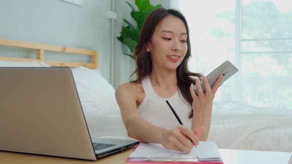 Business Startup of Young Asian women working with laptop for Online shopping at home alt