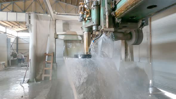 Large Industrial Stone Cutter Cuts Granite Rock Into Plates in Jets of Water Close Up