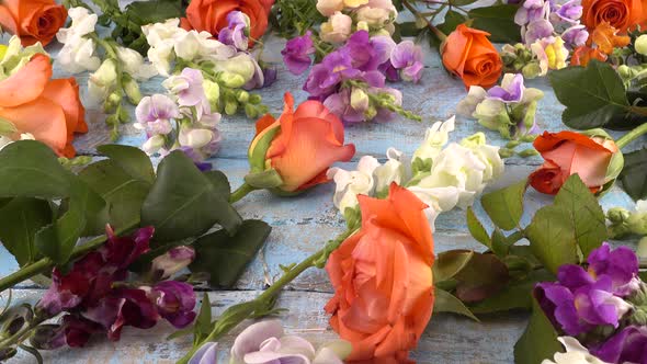 Colorful summer garden flowers: dragon flowers, roses, sweet pea on the vintage wooden alt
