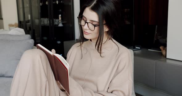 Attractive Woman Freelance Writer is Writing His Article on a Notebook alt