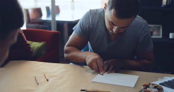 Student Linocuts Cut Out a Chisel or Other Cutting Tool on a Tablet Drawing alt